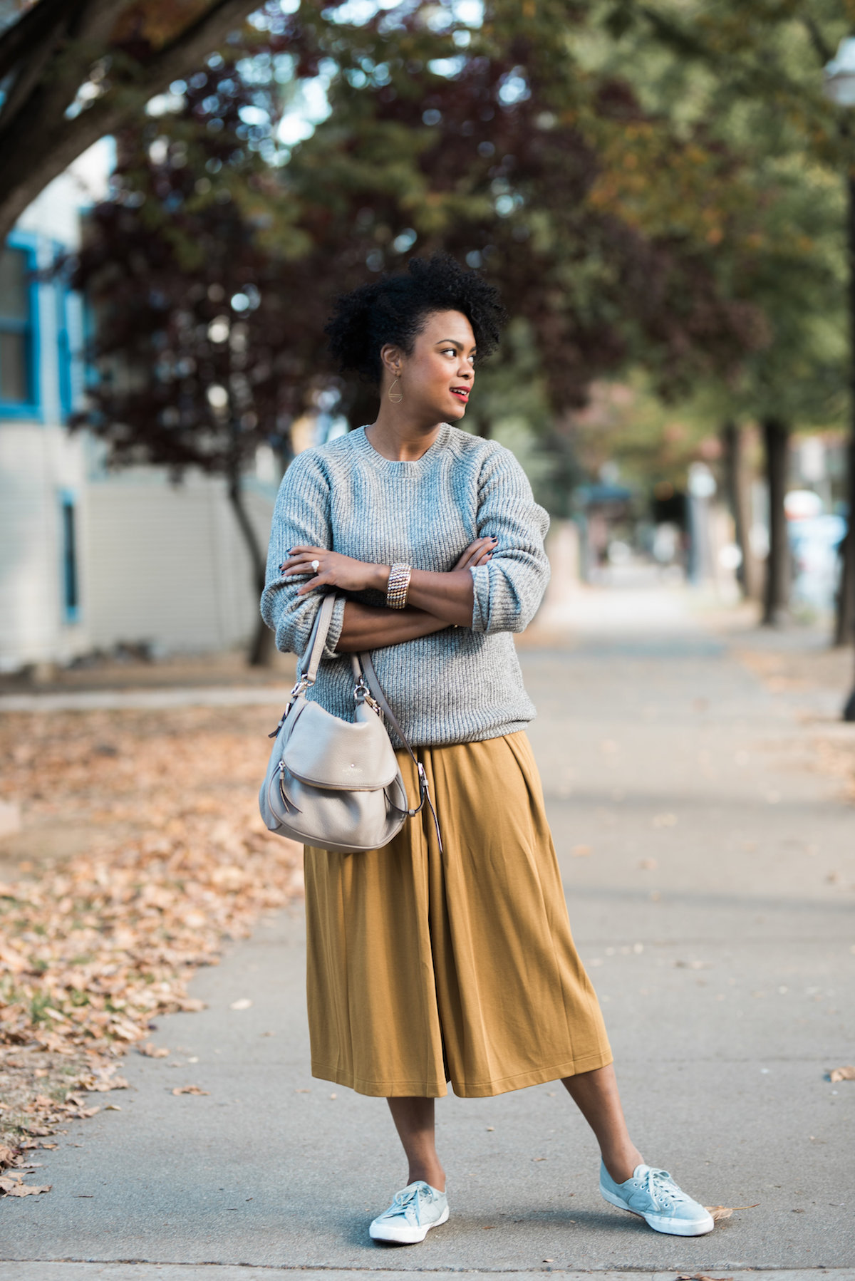 woman-wearing-mustard-yellow-culottes-with-sweater-and-sneakers