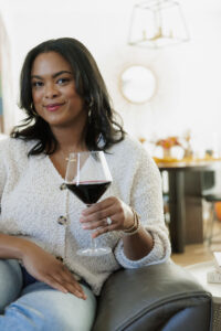 the kachet life - gratitude letter - pictured sitting on the sofa with a glass of wine