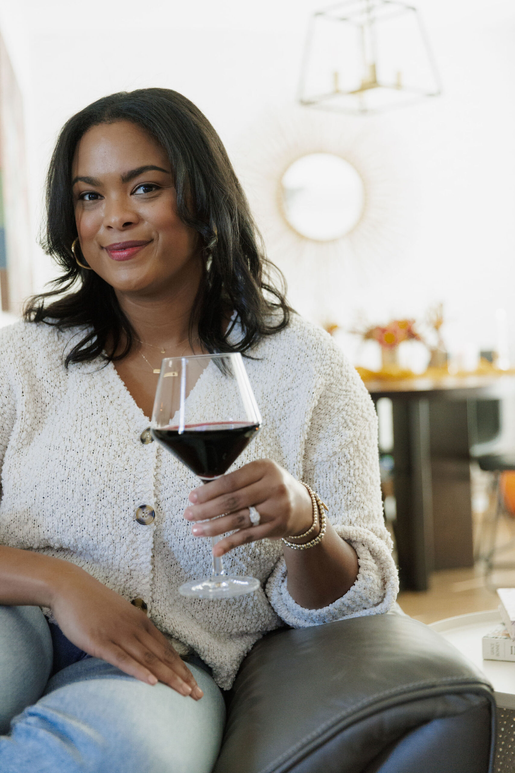 the kachet life - gratitude letter - pictured sitting on the sofa with a glass of wine